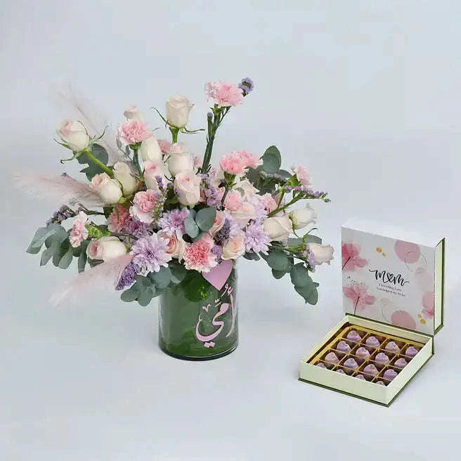 مجموعة الورد الخوخي والقرنفل مع علبة شوكولاتة مشكلة في فازة مصممة flowerna
